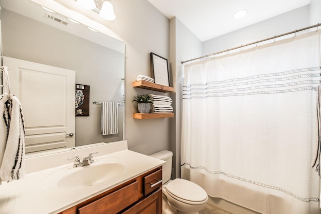 full bathroom featuring vanity, shower / tub combo, and toilet