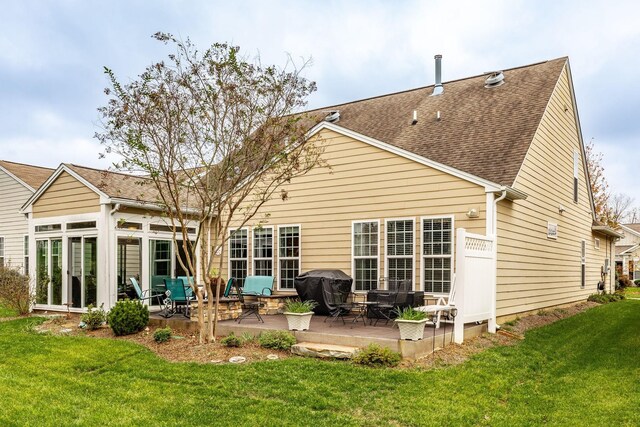 rear view of property featuring a patio area and a lawn