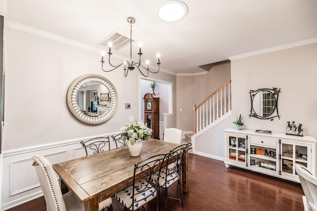 dining space with dark hardwood / wood-style flooring, ornamental molding, and a chandelier