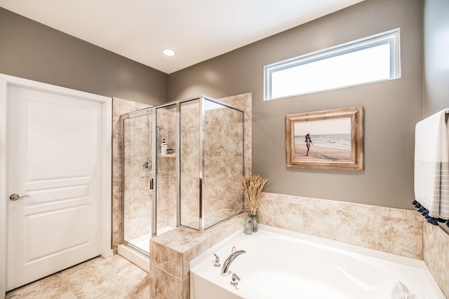 bathroom featuring separate shower and tub