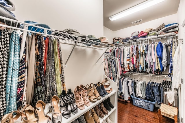 spacious closet featuring dark hardwood / wood-style floors