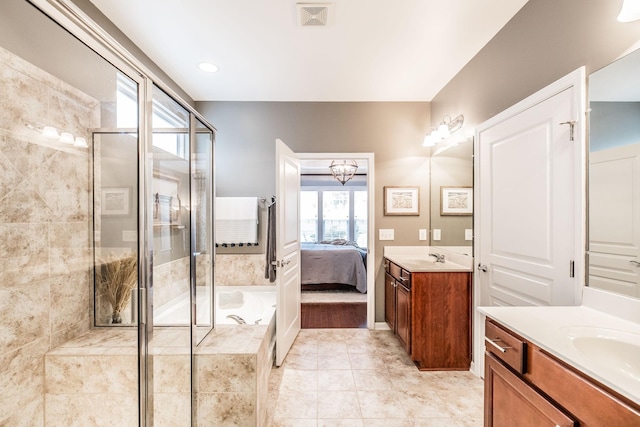 bathroom featuring a chandelier, vanity, independent shower and bath, and tile patterned flooring