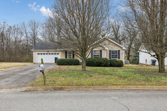 view of front of property with a garage and a front lawn