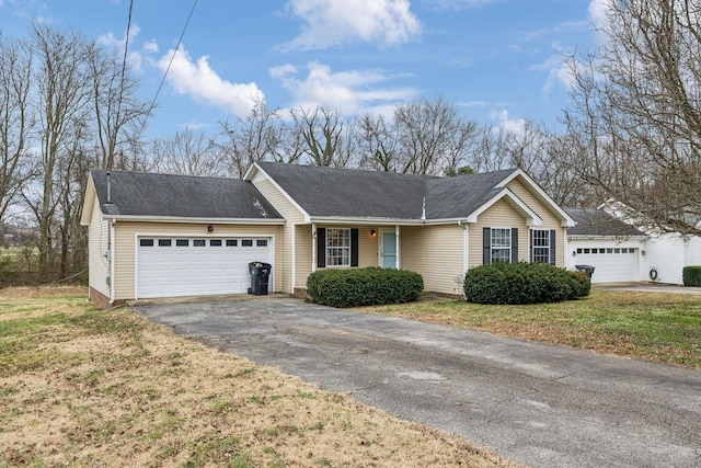 single story home with a garage and a front lawn