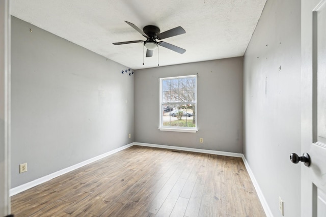 unfurnished room featuring ceiling fan, wood-type flooring, and a textured ceiling