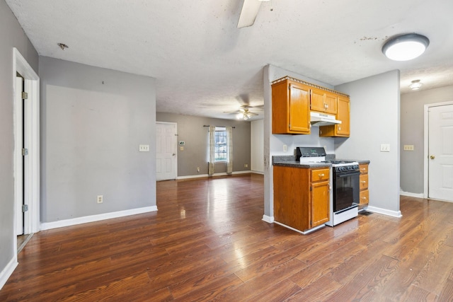 kitchen with a textured ceiling, gas range gas stove, ceiling fan, and dark hardwood / wood-style floors