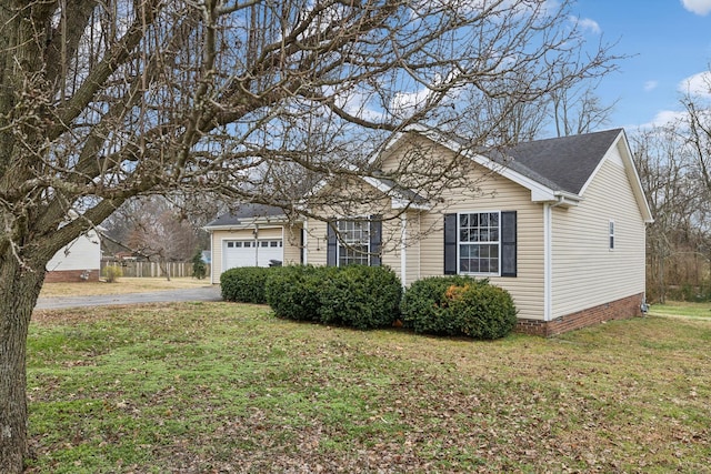 view of front facade with a front yard and a garage