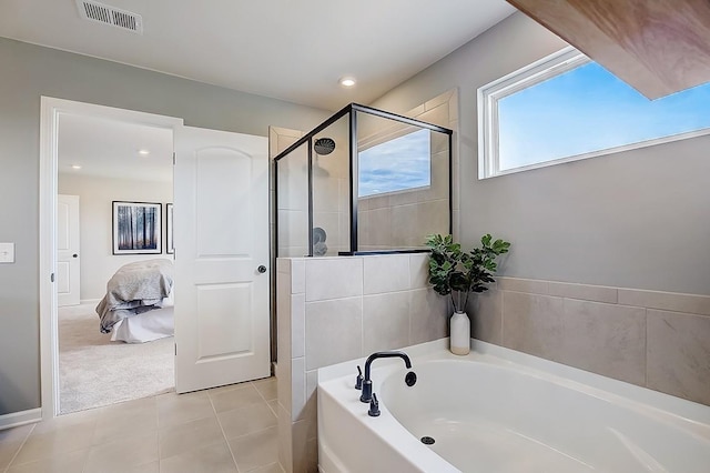 bathroom with tile patterned floors and separate shower and tub