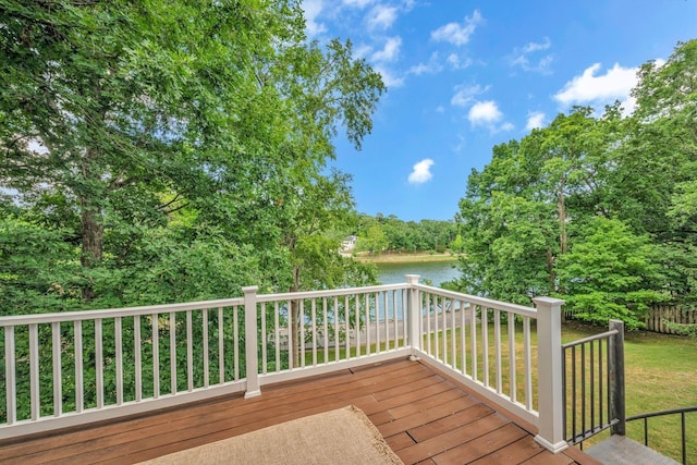 deck with a water view and a yard