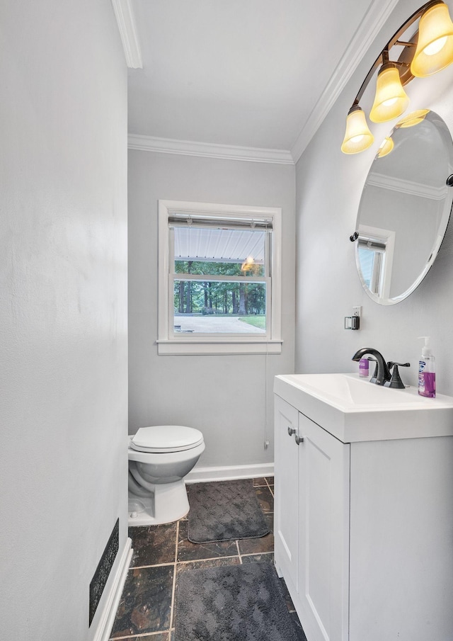 bathroom with vanity, toilet, and ornamental molding