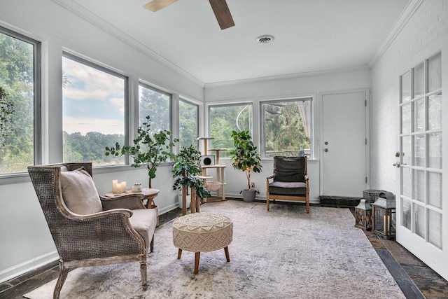 sunroom / solarium featuring ceiling fan