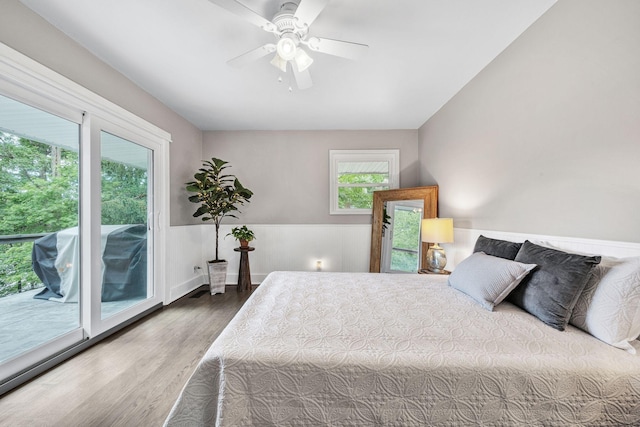 bedroom with hardwood / wood-style flooring, ceiling fan, and access to exterior