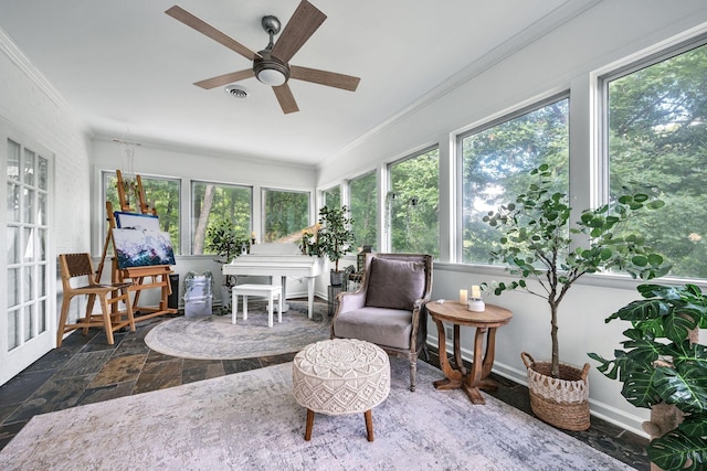 sunroom / solarium featuring ceiling fan