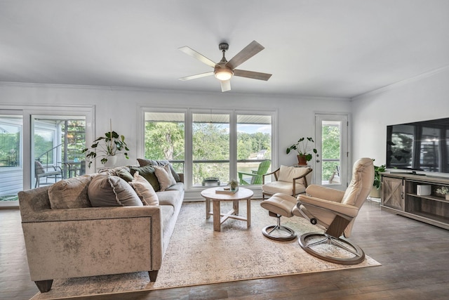 living room with hardwood / wood-style flooring, crown molding, ceiling fan, and a healthy amount of sunlight