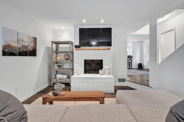 living room featuring ornamental molding and a brick fireplace