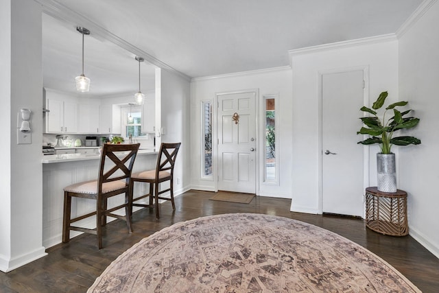 entrance foyer featuring ornamental molding and dark wood-type flooring