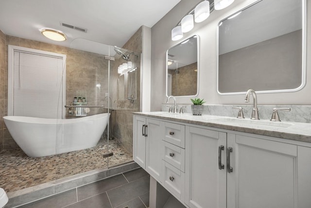 bathroom featuring tile patterned flooring, vanity, and separate shower and tub