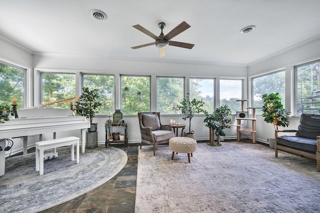 sunroom / solarium with ceiling fan and a healthy amount of sunlight