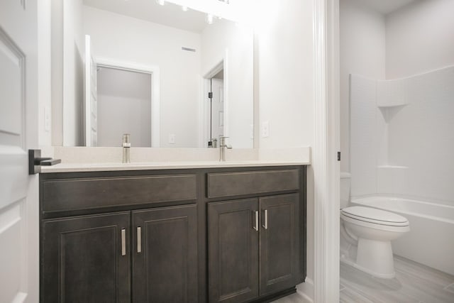 full bathroom featuring bathing tub / shower combination, hardwood / wood-style floors, vanity, and toilet