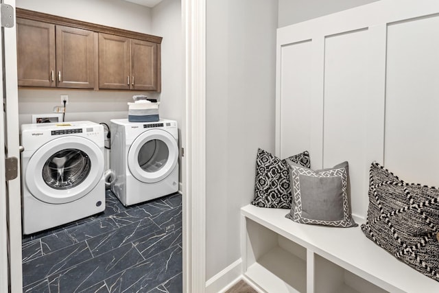 laundry area with cabinets and washing machine and clothes dryer