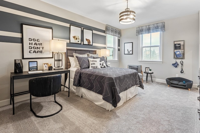 bedroom featuring carpet flooring and a chandelier