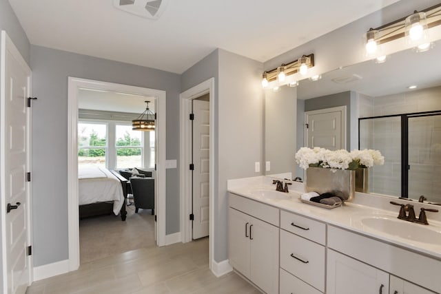 bathroom with tile patterned flooring, vanity, and an enclosed shower