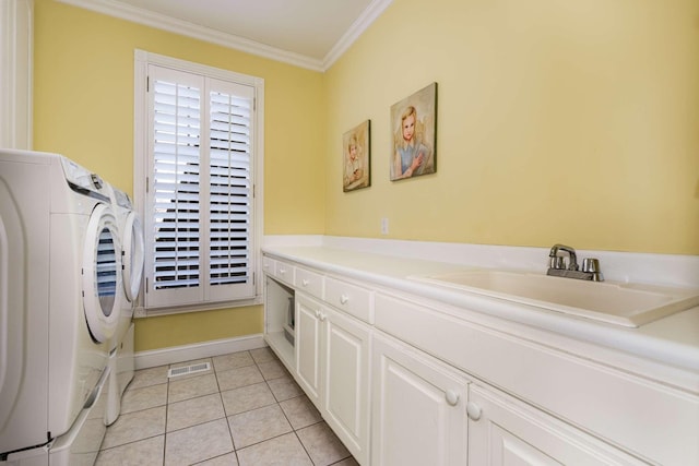 interior space with washer and dryer, sink, cabinets, ornamental molding, and light tile patterned floors