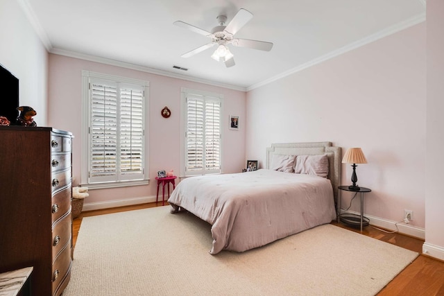 bedroom featuring crown molding, ceiling fan, and hardwood / wood-style floors