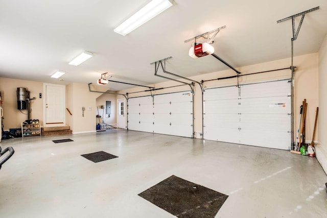 garage featuring electric panel and a garage door opener