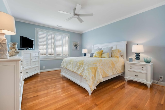 bedroom featuring ceiling fan, light hardwood / wood-style floors, and ornamental molding