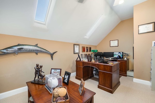 carpeted office space featuring lofted ceiling with skylight