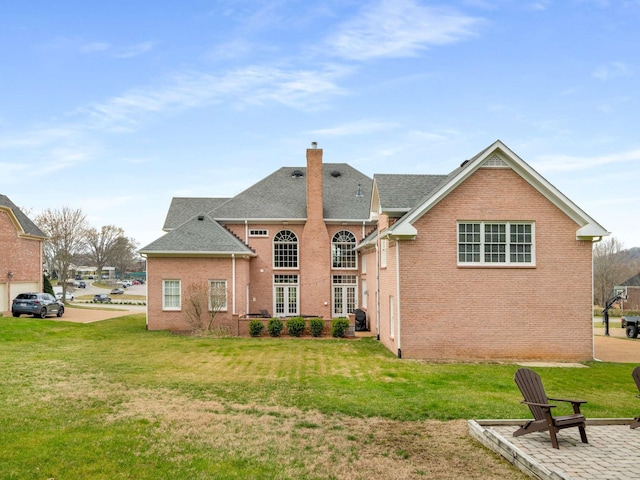 back of house with a yard and a patio area