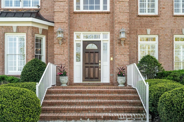 property entrance featuring brick siding