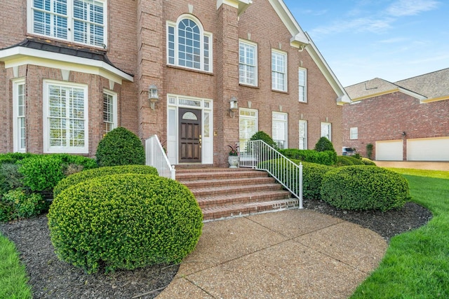 doorway to property featuring brick siding