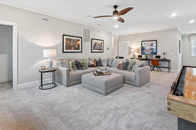 carpeted living room with ceiling fan and ornamental molding