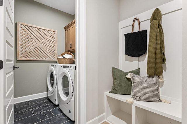 laundry area with cabinets and washing machine and clothes dryer