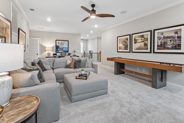 carpeted living room with ceiling fan and crown molding