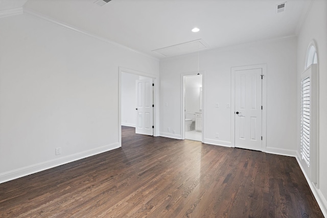 unfurnished bedroom featuring ensuite bath, dark hardwood / wood-style floors, and ornamental molding