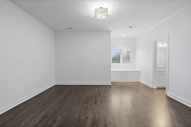 empty room featuring crown molding and dark wood-type flooring