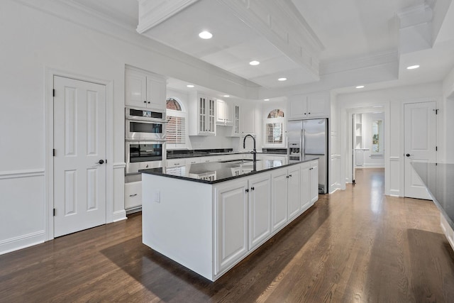 kitchen featuring white cabinetry, sink, dark hardwood / wood-style flooring, an island with sink, and appliances with stainless steel finishes