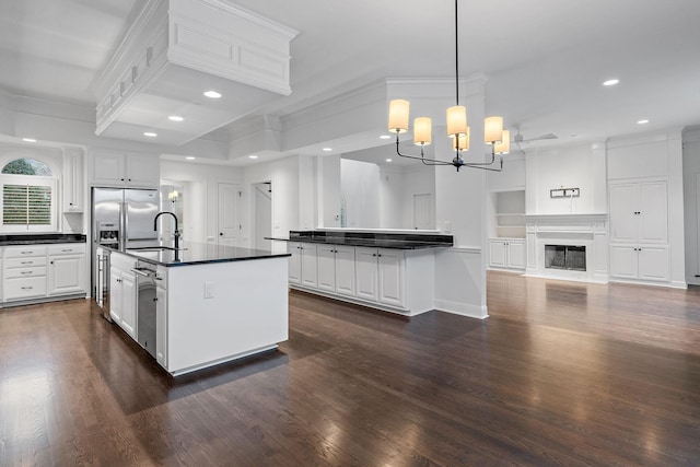 kitchen featuring white cabinetry, a chandelier, and decorative light fixtures