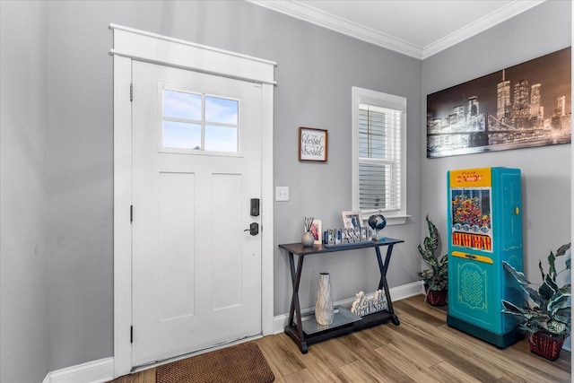 entrance foyer featuring a healthy amount of sunlight, crown molding, and hardwood / wood-style floors