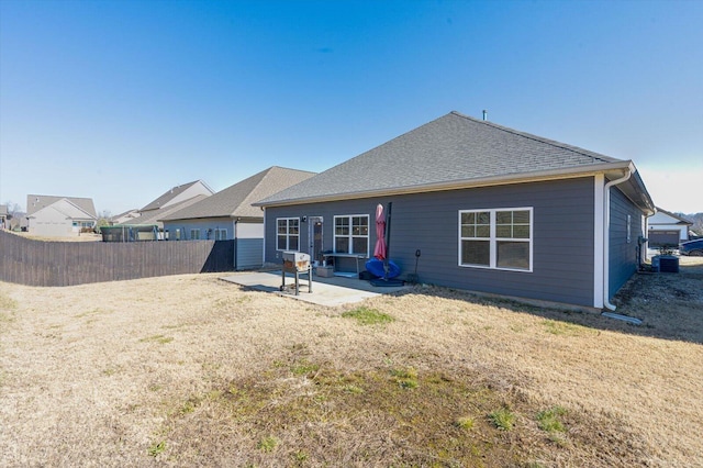 rear view of property with a yard and a patio