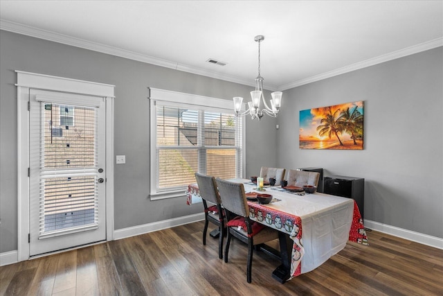 dining room featuring dark wood-type flooring, an inviting chandelier, and crown molding