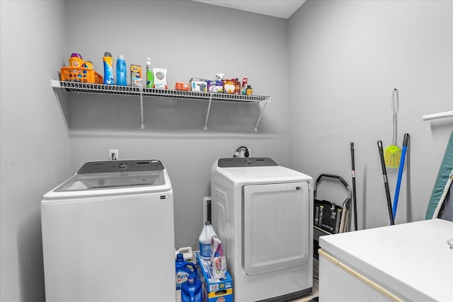 clothes washing area featuring separate washer and dryer