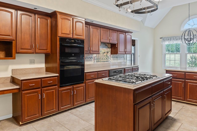 kitchen with lofted ceiling, crown molding, double oven, stainless steel gas cooktop, and decorative light fixtures