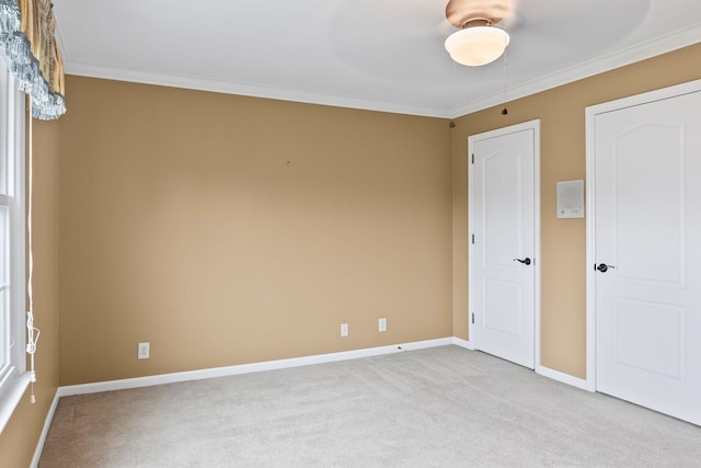 carpeted empty room featuring crown molding