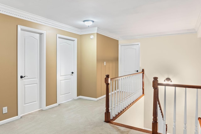 corridor with crown molding and light carpet