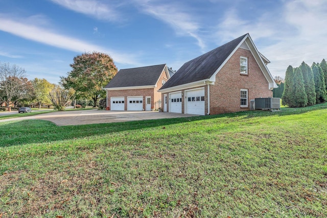 view of home's exterior featuring a garage, central AC, an outbuilding, and a lawn