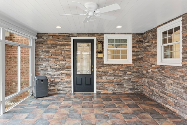 view of exterior entry with ceiling fan